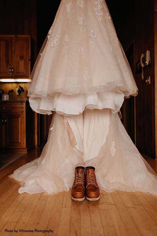 Red wing boots sit beneath bridal ballgown