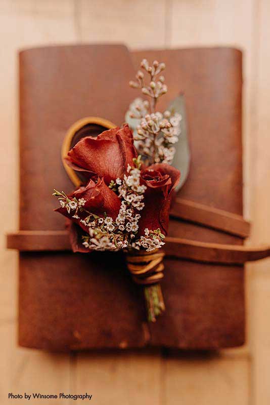 Fall boutonnière with rose and dried floral