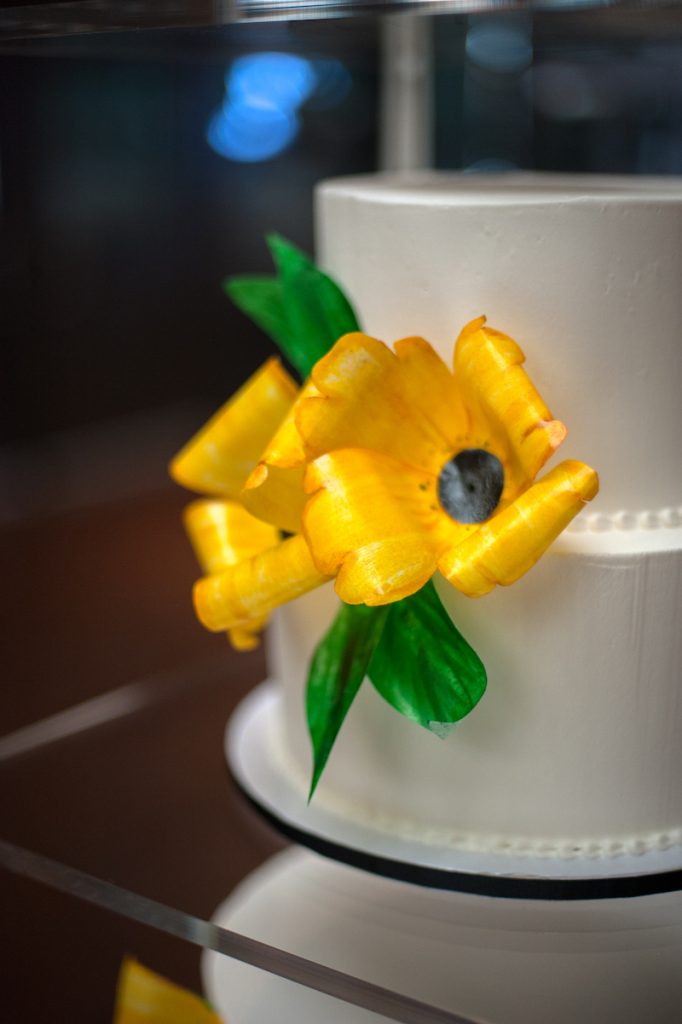 Simple white wedding cake with 2 large 3D yelloe flowers