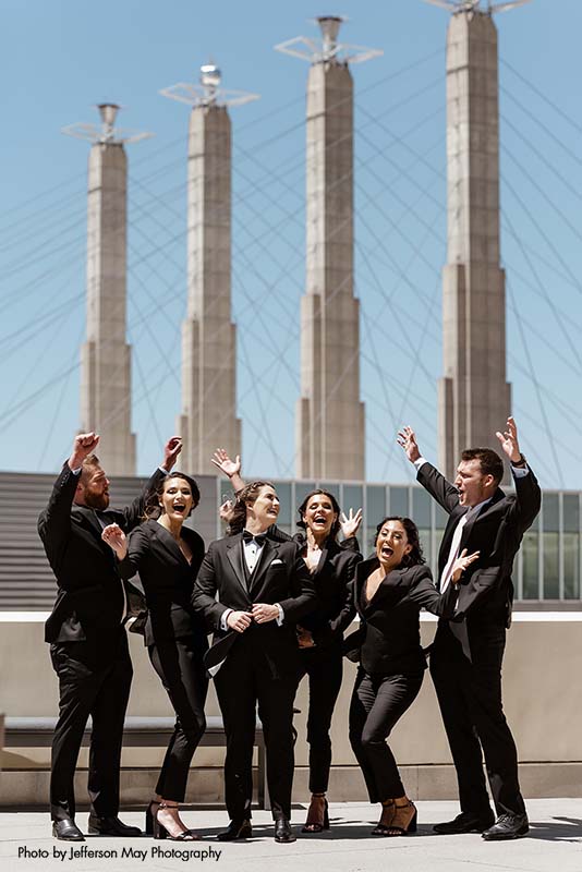 Mixed-gender wedding party in black tuxedos
