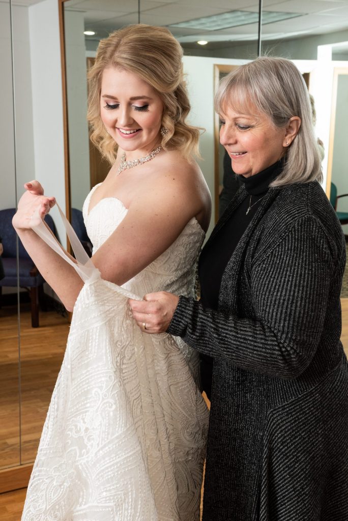 Cindy of Rapids Alterations and Repair alters bridal gown 