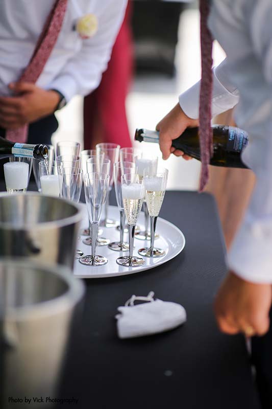 Classy champagne glasses at backyard wedding reception