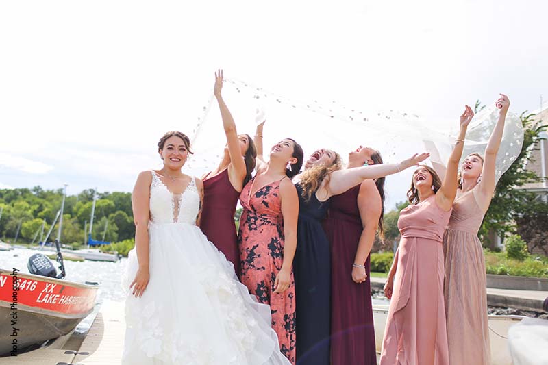 Bridesmaids in assorted colorful dresses for summer wedding