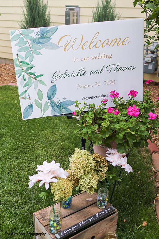 Floral backyard wedding welcome sign