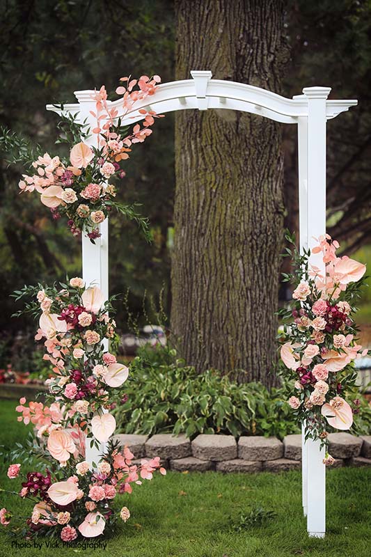 White wedding arch with summer flower