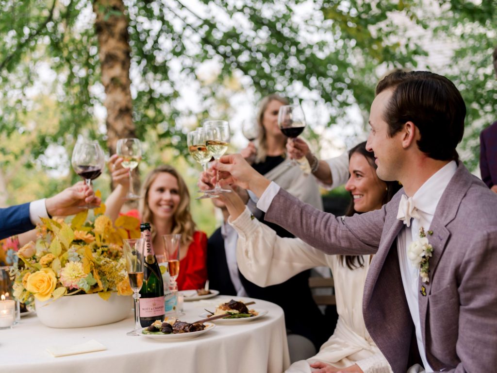 Group at wedding has a toast by Liz Banfield Photography 