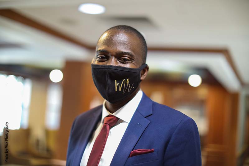 Groom in black face mask that says "Mr."