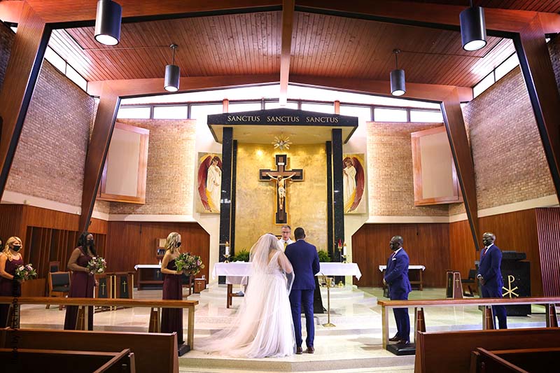 Couple stands at alter for Catholic wedding ceremony