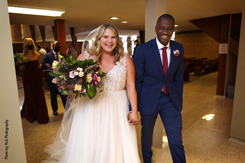 Bride and groom exit church after wedding ceremony in Minneapolis