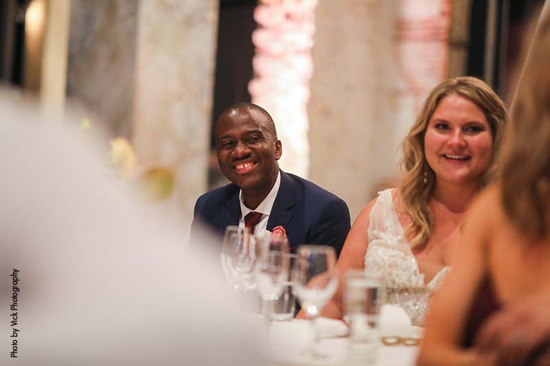 Bride and groom laugh at speeches