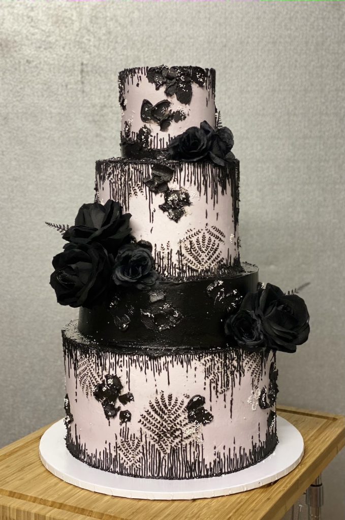 3-tier white and black wedding cake with black flowers 