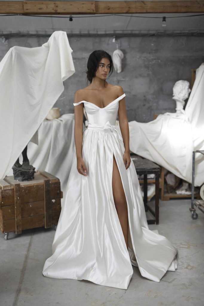 Off-the-shoulder satin wedding gown by Dana Harel 