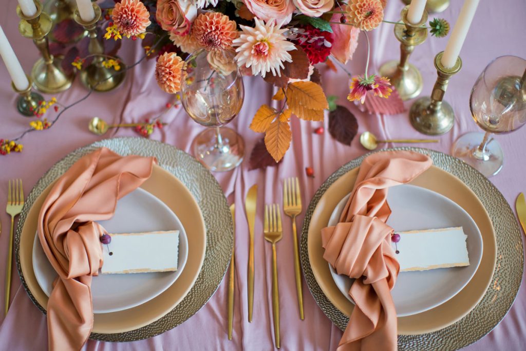 Beige wedding plate with pastel peach napkin on top