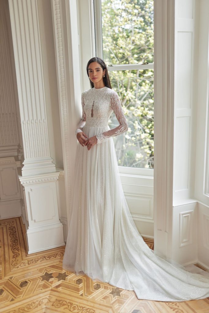 Bridal gown with sheath skirt and sweetheart nekline with detachable cape 