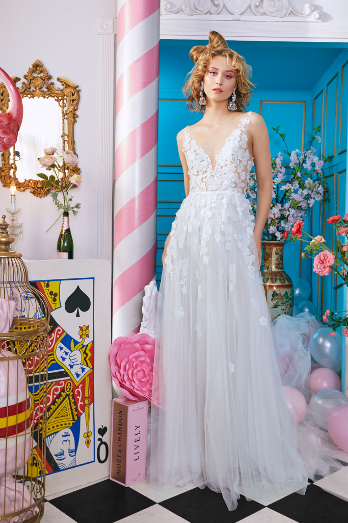 V-neck sheer embroidered ethereal A-line gown with 3 dimensional flowers.